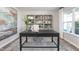 Inviting home office with large desk, built-in shelving, and natural light at 522 Lochalsh Dr, Gibsonville, NC 27249