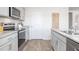 Well-lit kitchen with stainless steel appliances and granite countertops at 522 Lochalsh Dr, Gibsonville, NC 27249