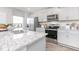 Contemporary kitchen boasts granite countertops, stainless steel appliances, and ample natural light at 522 Lochalsh Dr, Gibsonville, NC 27249