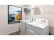 Laundry room with white appliances and colorful painting at 522 Lochalsh Dr, Gibsonville, NC 27249