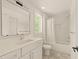Well-lit bathroom showcasing a sleek vanity, modern fixtures, and a bathtub with shower at 528 1/2 Bragg St, Raleigh, NC 27610