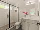 Modern bathroom with sleek glass shower, white subway tile, and stylish vanity at 528 1/2 Bragg St, Raleigh, NC 27610