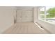 Sunlit bedroom featuring neutral carpet, a large window with pleasant views, and ample closet space at 528 1/2 Bragg St, Raleigh, NC 27610
