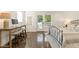 A bedroom offers a modern desk, polished floors, and a convenient walkout door for easy outdoor access, creating comfort at 528 1/2 Bragg St, Raleigh, NC 27610