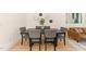 Charming dining space featuring a wooden table, gray upholstered chairs, and wall decor, perfect for entertaining at 528 1/2 Bragg St, Raleigh, NC 27610