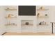 Modern living room featuring built-in shelving, entertainment center and hardwood floors at 528 1/2 Bragg St, Raleigh, NC 27610