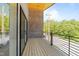 Spacious balcony area with wooden floors, black railings and brick walls, offering an inviting outdoor space at 528 Bragg St, Raleigh, NC 27610