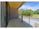 Stylish balcony featuring wood floors, brick wall, and a sleek black railing at 528 Bragg St, Raleigh, NC 27610