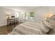 Bedroom featuring gray and white linens and view to outside through the door and window at 528 Bragg St, Raleigh, NC 27610