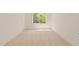 Bright bedroom features plush carpet, large window with green outdoor views and neutral paint at 528 Bragg St, Raleigh, NC 27610