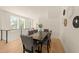 Elegant dining room with a wooden table, seating for eight, and abundant natural light from large windows at 528 Bragg St, Raleigh, NC 27610