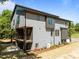 Modern gray two-story home featuring clean lines, a side deck, and minimalist landscaping at 528 Bragg St, Raleigh, NC 27610