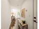 Bright hallway features modern console table, decor and durable polished concrete flooring at 528 Bragg St, Raleigh, NC 27610