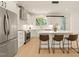 Modern kitchen with white cabinets, stainless steel appliances, a center island, and stylish bar stools at 528 Bragg St, Raleigh, NC 27610