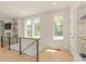 Upstairs landing with modern railing, sunlit windows, and stylish decor at 528 Bragg St, Raleigh, NC 27610