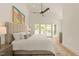 Inviting main bedroom with vaulted ceiling, ceiling fan, and sliding door leading to a balcony at 528 Bragg St, Raleigh, NC 27610
