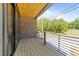 Covered porch with wood flooring, brick wall and a metal railing providing a relaxing outdoor space at 528 Bragg St, Raleigh, NC 27610