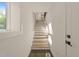 Bright, modern staircase with wood steps and white walls illuminated by natural light at 528 Bragg St, Raleigh, NC 27610