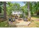 Backyard featuring a fire pit surrounded by Adirondack chairs with a view of the house at 5312 Hallmark Rd, Durham, NC 27712