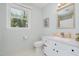 Bathroom with a white vanity and toilet next to a window for natural light at 5312 Hallmark Rd, Durham, NC 27712