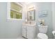 Bathroom featuring a white vanity, a toilet, and a window that offers natural light at 5312 Hallmark Rd, Durham, NC 27712