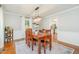 Elegant dining room with chandelier, wood table, and a window with view of the outdoor at 5312 Hallmark Rd, Durham, NC 27712
