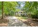 Inviting two-story home featuring traditional design, surrounded by mature trees, set back on private lot at 5312 Hallmark Rd, Durham, NC 27712