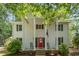 Welcoming front porch with classic columns, a bright red door, and comfortable rocking chairs at 5312 Hallmark Rd, Durham, NC 27712
