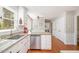 Kitchen featuring white cabinets, stainless appliances, granite counters and a breakfast bar area at 5312 Hallmark Rd, Durham, NC 27712