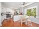 Bright kitchen with white cabinets, stainless steel appliances, and a cozy breakfast nook at 5312 Hallmark Rd, Durham, NC 27712