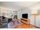 Bright living room featuring hardwood floors, a large window, and comfortable seating at 5312 Hallmark Rd, Durham, NC 27712