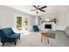 Cozy living room with a fireplace, white brick surround, access to a deck and plush furnishings at 5312 Hallmark Rd, Durham, NC 27712