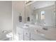 Bright bathroom featuring double sink vanity with white cabinets and ample counter space at 5912 Hourglass Ct, Raleigh, NC 27612