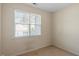 A bright bedroom features a window with blinds and neutral carpet flooring at 5912 Hourglass Ct, Raleigh, NC 27612