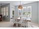Bright dining room with a modern table, comfortable seating, and plenty of natural light at 5912 Hourglass Ct, Raleigh, NC 27612