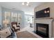 Spacious living room featuring a fireplace, modern furnishings, and an adjacent dining area at 5912 Hourglass Ct, Raleigh, NC 27612