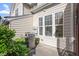 Back patio with a stainless steel grill, surrounded by lush greenery and privacy at 5912 Hourglass Ct, Raleigh, NC 27612