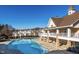Large community pool next to clubhouse with a clear blue sky at 5912 Hourglass Ct, Raleigh, NC 27612