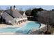 Community pool area with clubhouse and surrounding landscape at 5912 Hourglass Ct, Raleigh, NC 27612