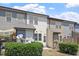 Townhome backyard view, showing multiple windows, neutral siding and small lawn at 709 Wickham Ridge Rd, Apex, NC 27539