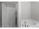Bathroom with glass-enclosed shower and garden tub at 709 Wickham Ridge Rd, Apex, NC 27539
