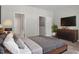 Comfortable bedroom with plush bedding, modern dresser, and soft carpeting at 709 Wickham Ridge Rd, Apex, NC 27539