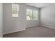 Bedroom featuring neutral carpet, light gray walls, and ample natural light at 709 Wickham Ridge Rd, Apex, NC 27539