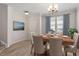 Elegant dining room with hardwood floors, a chandelier, and bright natural light at 709 Wickham Ridge Rd, Apex, NC 27539