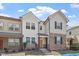 Beautiful townhome with stone accents, complemented by manicured landscaping and a welcoming entrance at 709 Wickham Ridge Rd, Apex, NC 27539