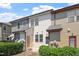 Townhome exterior with multiple windows, neutral siding and mature landscaping at 709 Wickham Ridge Rd, Apex, NC 27539