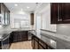 Modern kitchen with granite countertops, stainless steel appliances, and dark wood cabinets at 709 Wickham Ridge Rd, Apex, NC 27539