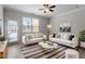 Stylish living room featuring neutral decor, modern furnishings, and ample natural light at 709 Wickham Ridge Rd, Apex, NC 27539