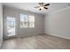 Bright living room with modern floors, ceiling fan and access to back patio at 709 Wickham Ridge Rd, Apex, NC 27539