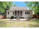 Expansive backyard featuring a screened-in porch, patio area with a fire pit, and lush green lawn at 715 Kimbrough St, Raleigh, NC 27608